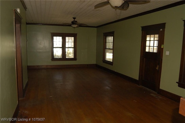 empty room with dark wood-type flooring and ornamental molding