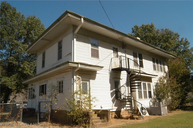 back of property with a balcony