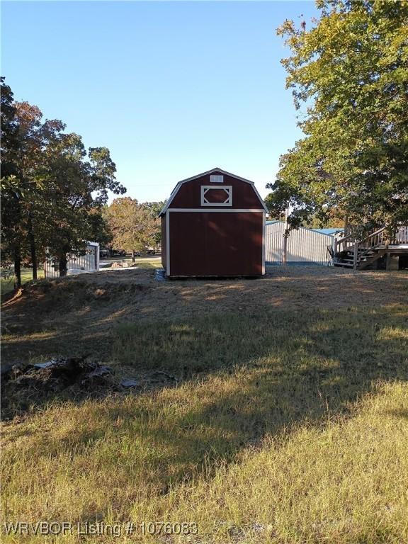 view of outdoor structure featuring a lawn