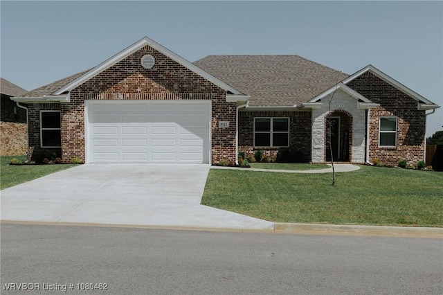 9121 Wayne Xing, Fort Smith, AR 72916 - view of front facade featuring driveway, an attached garage, a front yard, brick siding, and a shingled roof