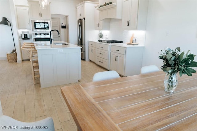 9121 Wayne Xing, Fort Smith, AR 72916 - kitchen featuring a sink, stainless steel appliances, a kitchen island with sink, and light countertops