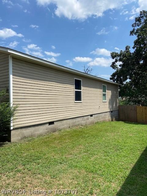 view of home's exterior with a yard