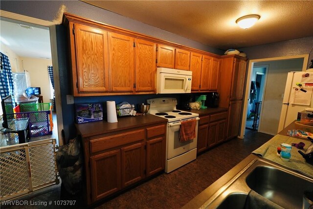 kitchen with white appliances and sink