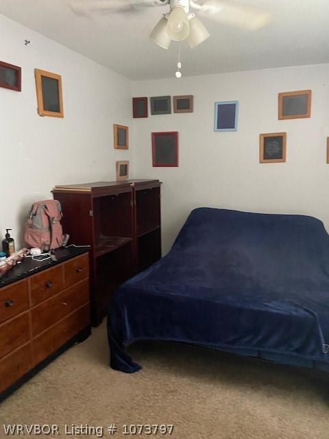 carpeted bedroom with ceiling fan