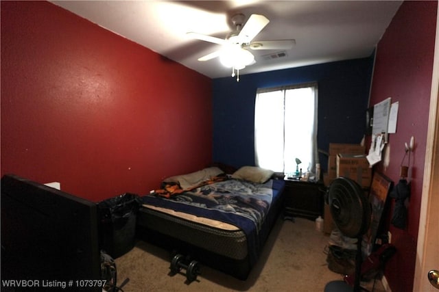 bedroom with ceiling fan and light carpet