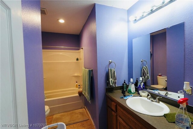 full bathroom featuring tile patterned flooring, vanity, bathtub / shower combination, and toilet