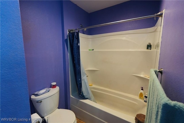 bathroom with toilet and shower / bath combo with shower curtain