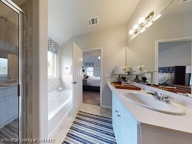 8011 Windflower Ln, Fort Smith, AR 72916 - bathroom with ensuite bathroom, vanity, a bath, a shower with shower door, and vaulted ceiling