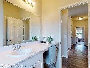 8011 Windflower Ln, Fort Smith, AR 72916 - bathroom with wood finished floors and vanity