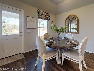 8011 Windflower Ln, Fort Smith, AR 72916 - dining area with plenty of natural light and dark wood-type flooring