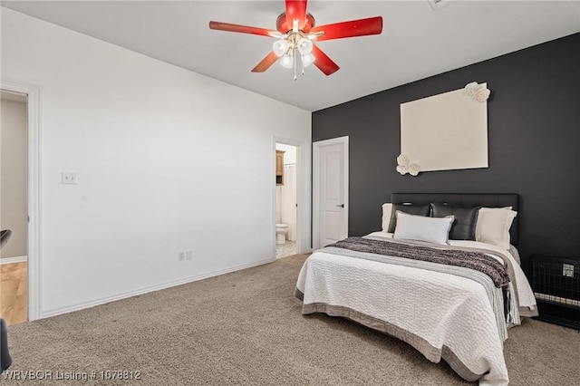 carpeted bedroom featuring ceiling fan and ensuite bath