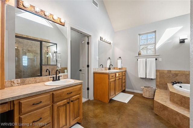 bathroom featuring vanity, vaulted ceiling, concrete floors, and independent shower and bath