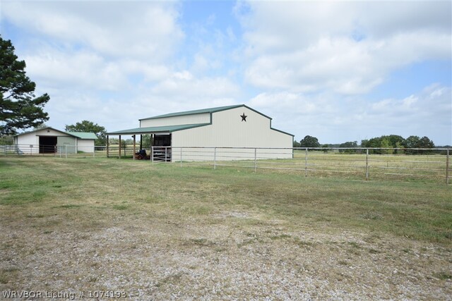 view of yard featuring a rural view and an outdoor structure