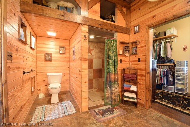 bathroom featuring walk in shower and wooden walls