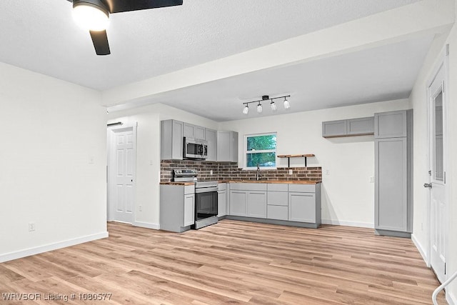 301 Choctaw St, Hackett, AR 72937 - kitchen with gray cabinets, a ceiling fan, appliances with stainless steel finishes, and light wood-style flooring