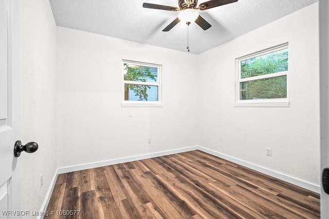 301 Choctaw St, Hackett, AR 72937 - spare room featuring a wealth of natural light, ceiling fan, dark wood-style flooring, and baseboards