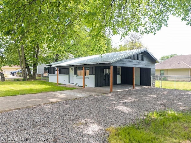301 Choctaw St, Hackett, AR 72937 - view of front of property with a front yard, metal roof, board and batten siding, concrete driveway, and fence