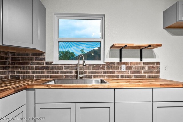 301 Choctaw St, Hackett, AR 72937 - kitchen featuring wood counters, decorative backsplash, white cabinets, and a sink