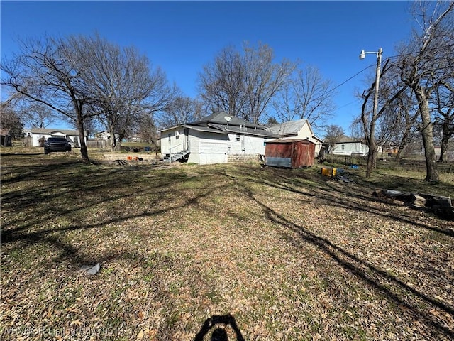 exterior space with a yard and an outbuilding