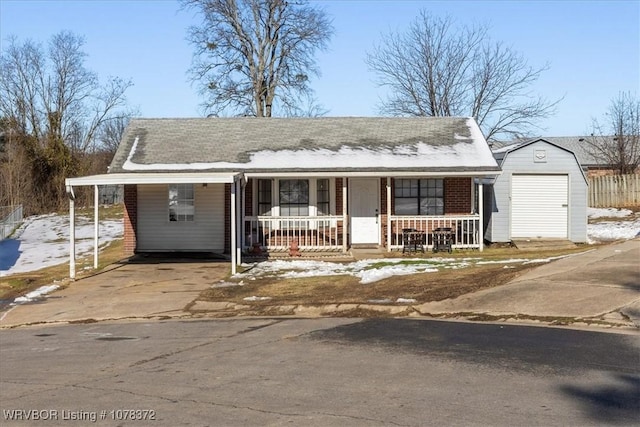 view of front of property featuring a garage, covered porch, and an outbuilding