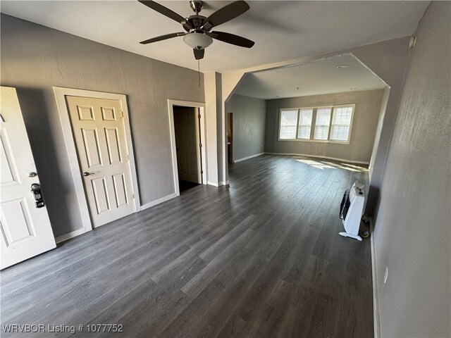 1216 N 13th St, Fort Smith, AR 72901 - unfurnished living room with heating unit, dark hardwood / wood-style floors, and ceiling fan