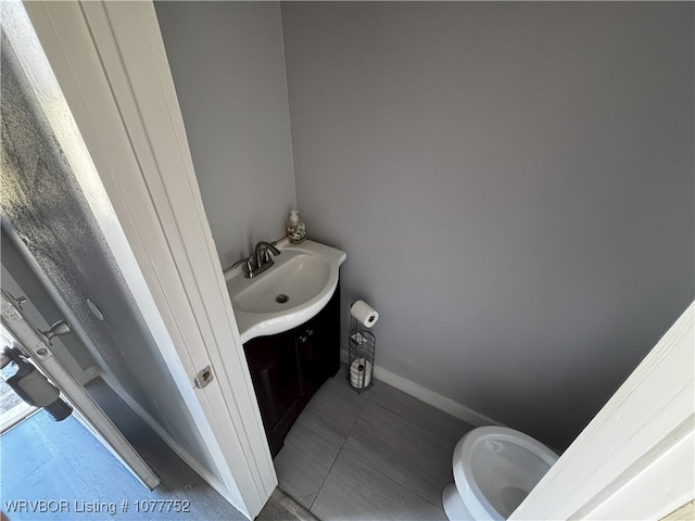 1216 N 13th St, Fort Smith, AR 72901 - bathroom with tile patterned floors, vanity, and toilet