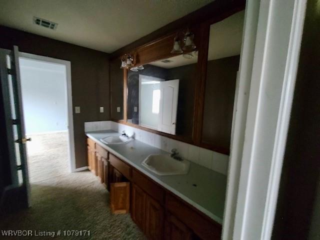 bathroom featuring a sink and visible vents