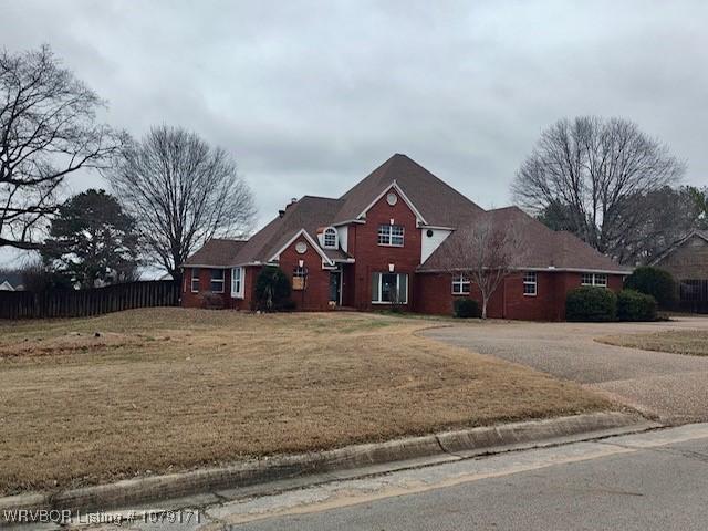 traditional-style home with fence and a front yard