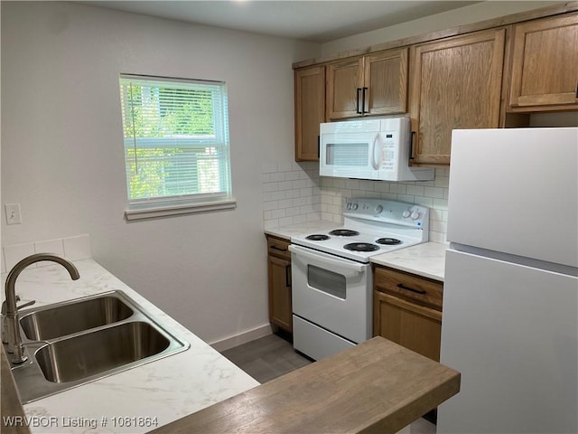 4223 High St, Fort Smith, AR 72904 - kitchen with white appliances, backsplash, light countertops, brown cabinetry, and wood finished floors