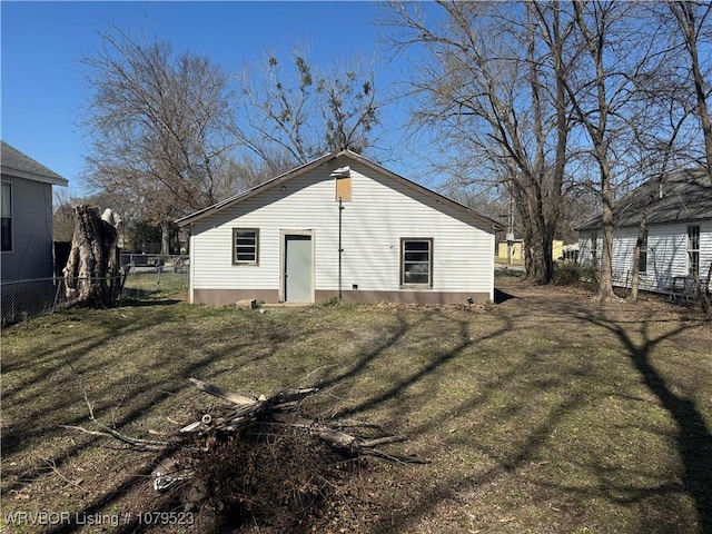 exterior space featuring fence and a lawn