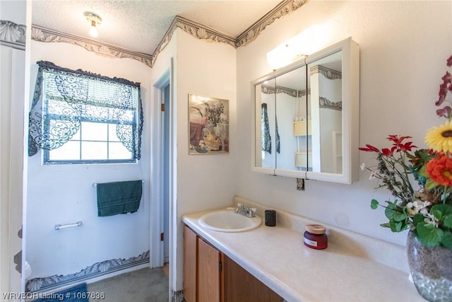 bathroom with vanity and a textured ceiling