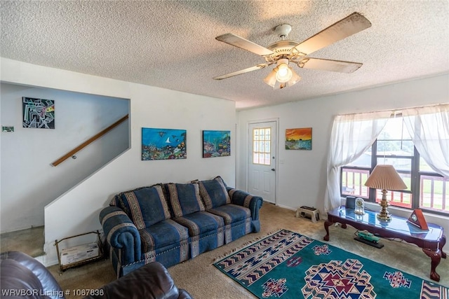 living room featuring carpet, a textured ceiling, and ceiling fan