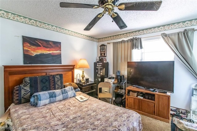 bedroom with carpet, a textured ceiling, and ceiling fan