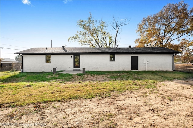 rear view of house with a yard