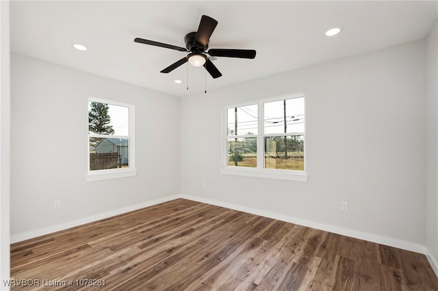 empty room with hardwood / wood-style flooring and ceiling fan