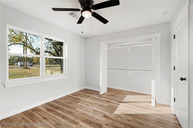 unfurnished bedroom with ceiling fan, light hardwood / wood-style flooring, and a closet