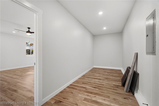 hallway featuring light wood-type flooring and electric panel