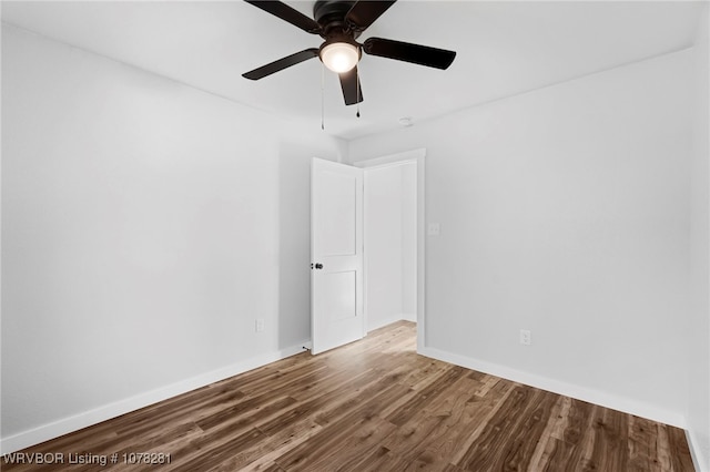 spare room with ceiling fan and wood-type flooring