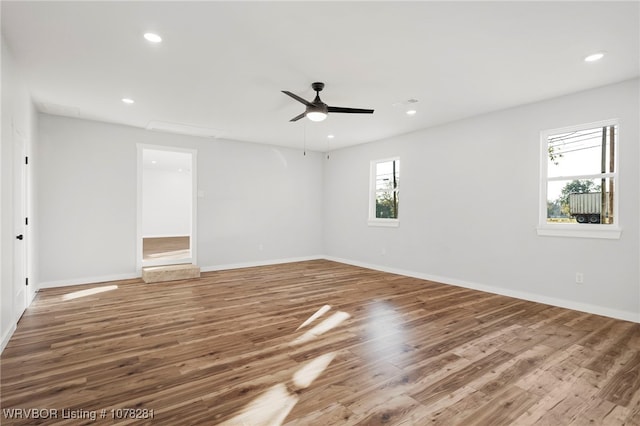 empty room with ceiling fan and hardwood / wood-style floors