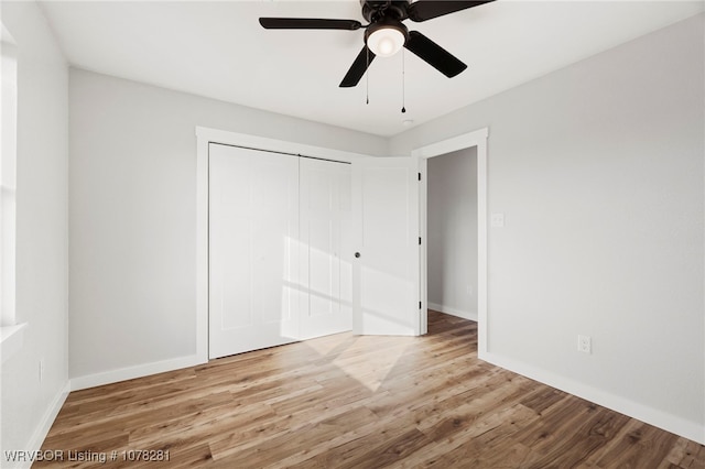 unfurnished bedroom featuring light wood-type flooring, a closet, and ceiling fan