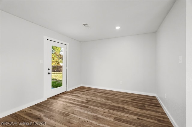 unfurnished room with hardwood / wood-style floors