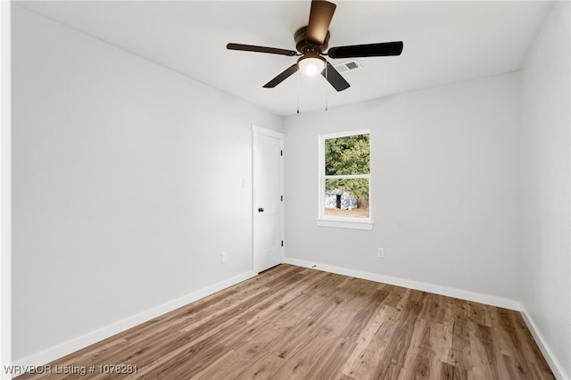 empty room featuring light wood-type flooring and ceiling fan