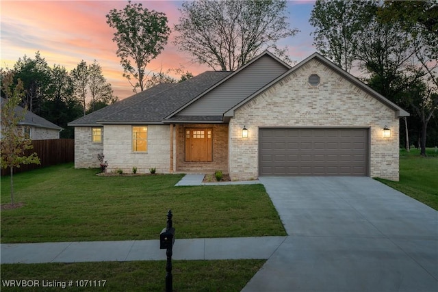 view of front of house featuring a lawn and a garage