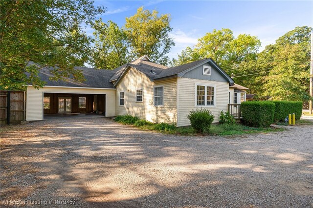 exterior space featuring gravel driveway and a garage