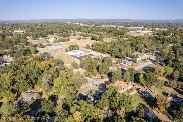 birds eye view of property featuring a view of trees