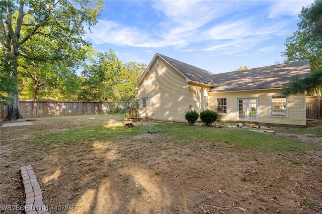 exterior space featuring french doors, a yard, and fence