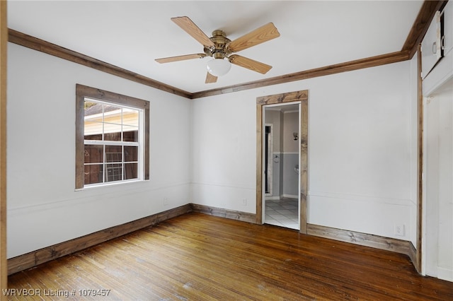 spare room with ceiling fan, baseboards, hardwood / wood-style floors, and crown molding