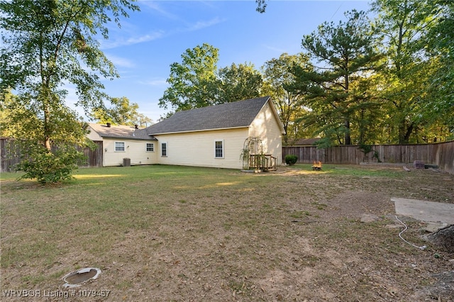 view of yard featuring central AC and a fenced backyard