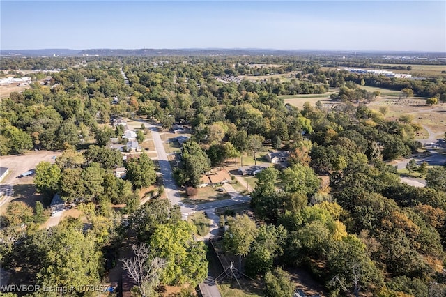 drone / aerial view with a wooded view