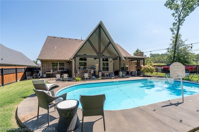 view of pool with a lawn and a patio area